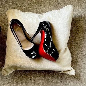 Christian Louboutin peep toe heals.